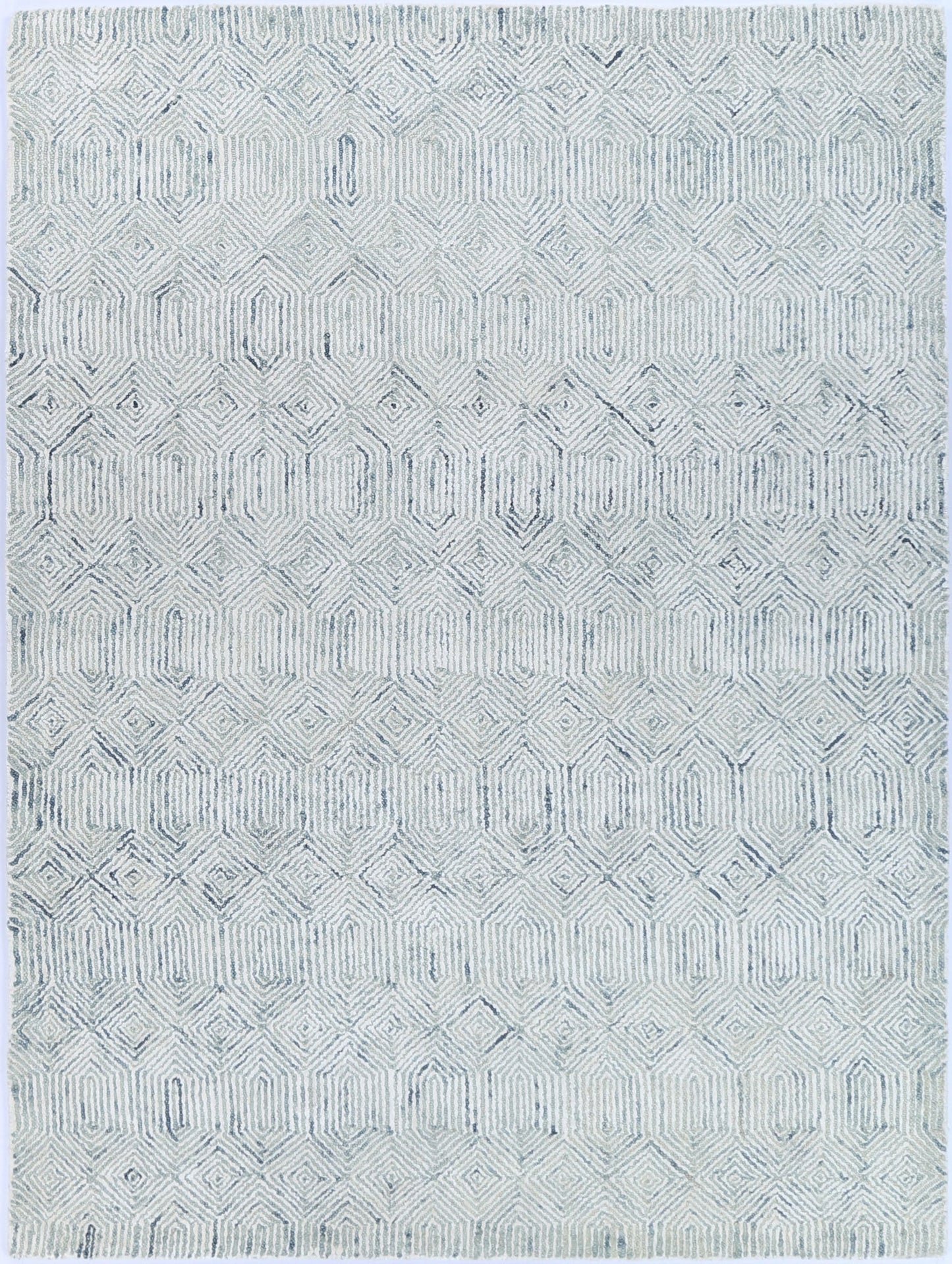 Detailed side view of Astrid Seafoam rug in space