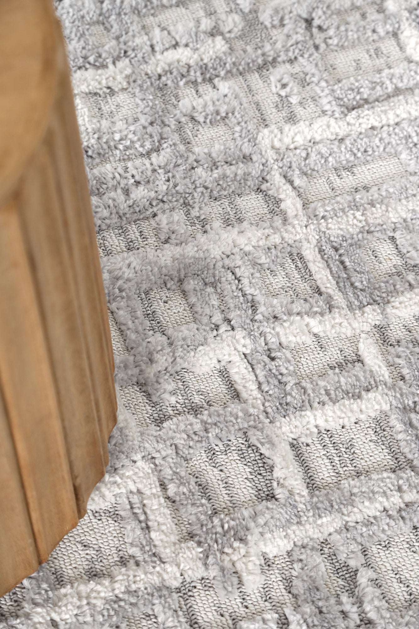 Grey rug detail in a softly lit interior